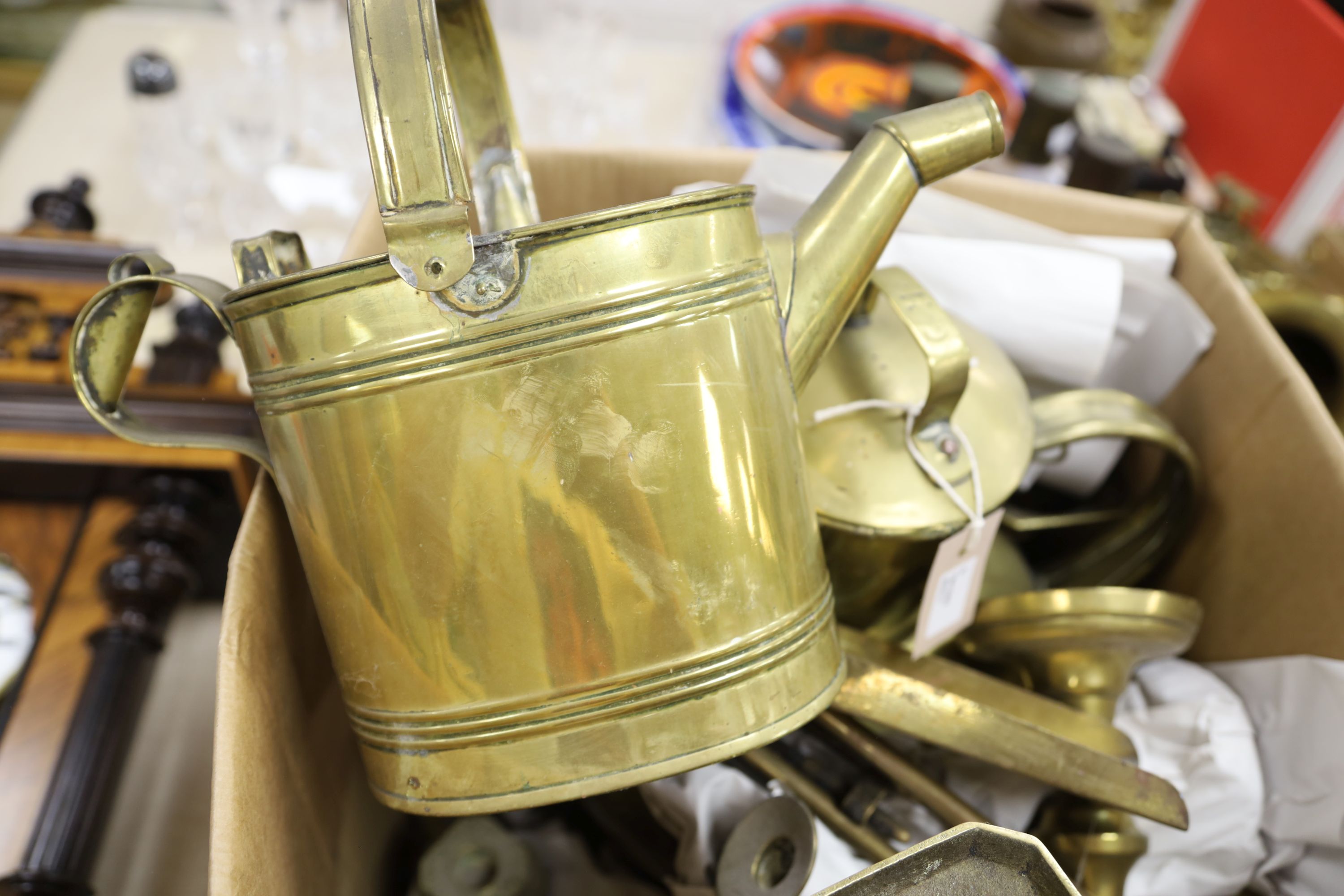 Collection of brass candlesticks, an Edwardian brass hot water jug, another brass jug and cover and a set of kitchen scales and weights